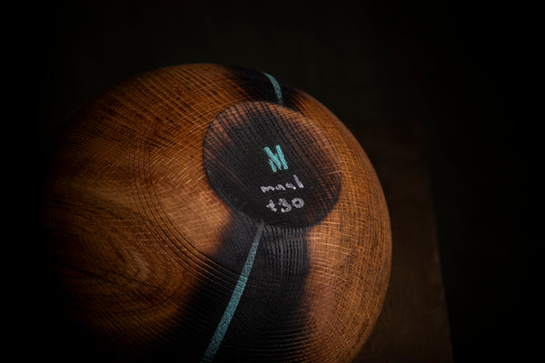A close-up of  a bottom of a wooden hollow form.