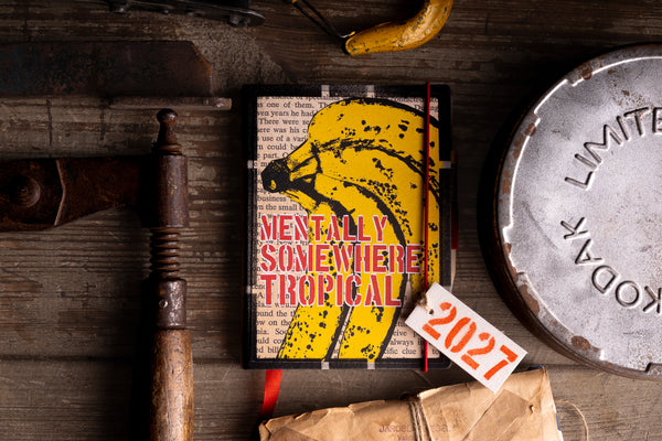 "The Tropical Soul" 2027 diary cover flat lay styled with vintage tool