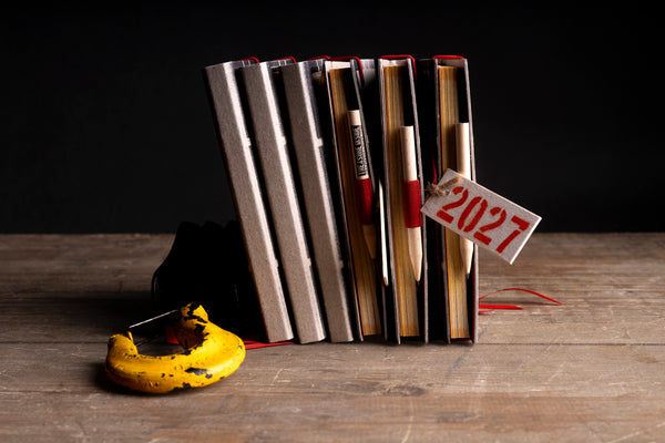 pencil-detail-stack.jpg — Close-up of pencils tucked into diary spines, printed with "Treasure Inside deafmessanger.com"