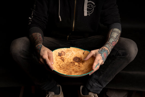 Evie, a handmade maple burl bowl by Maalström Studio with a natural edge.