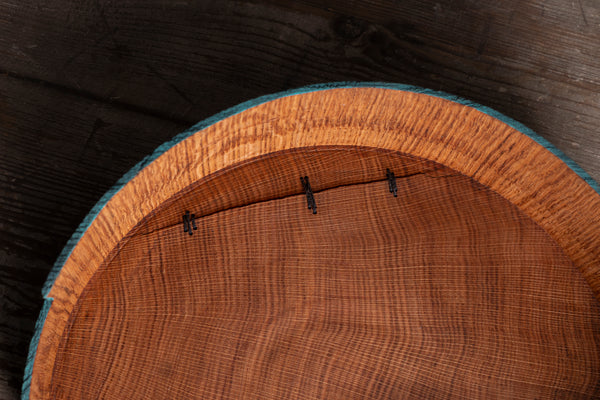 Close up of an inside of hand turned wooden bowl from red oak showing stitches securing the crack. 
